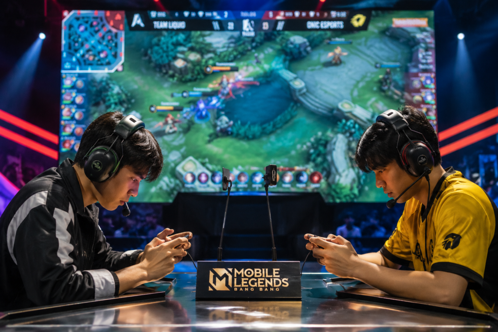 Two esports players competing in an intense Asian Games 2026 MLBB match on stage.