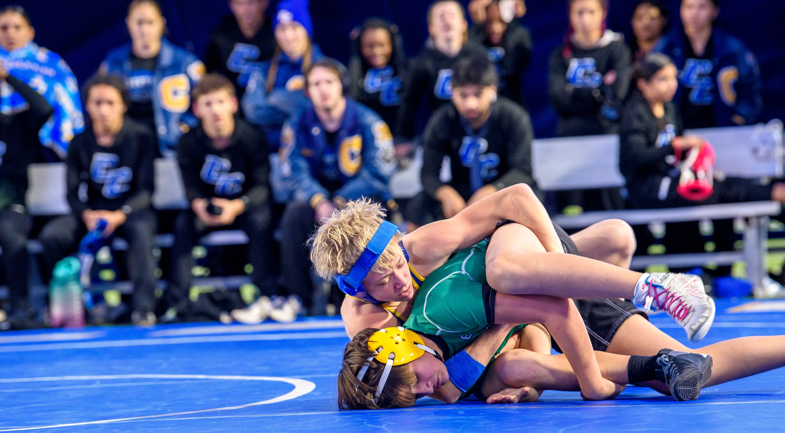 wrestling match with competitors in action on the mat.